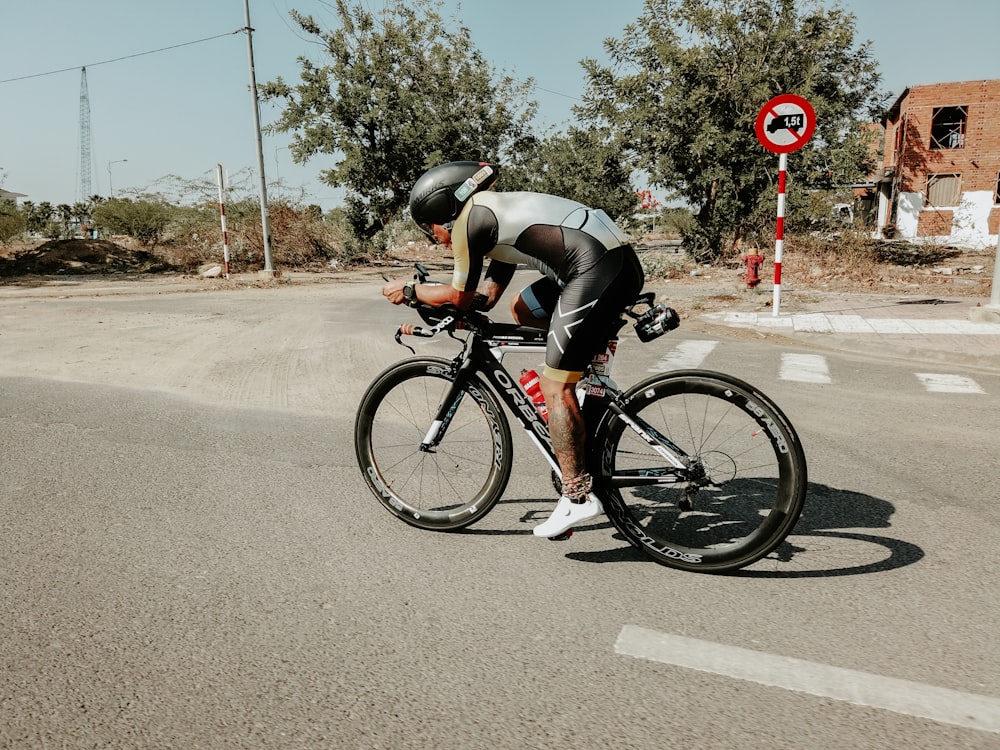 man biking on road during daytime