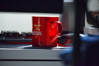 Close-up of a sleek Corporate Diva coffee mug with bold logo on a modern office desk.