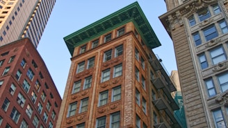 low-angle photography of brown high-rise buildings during daytime