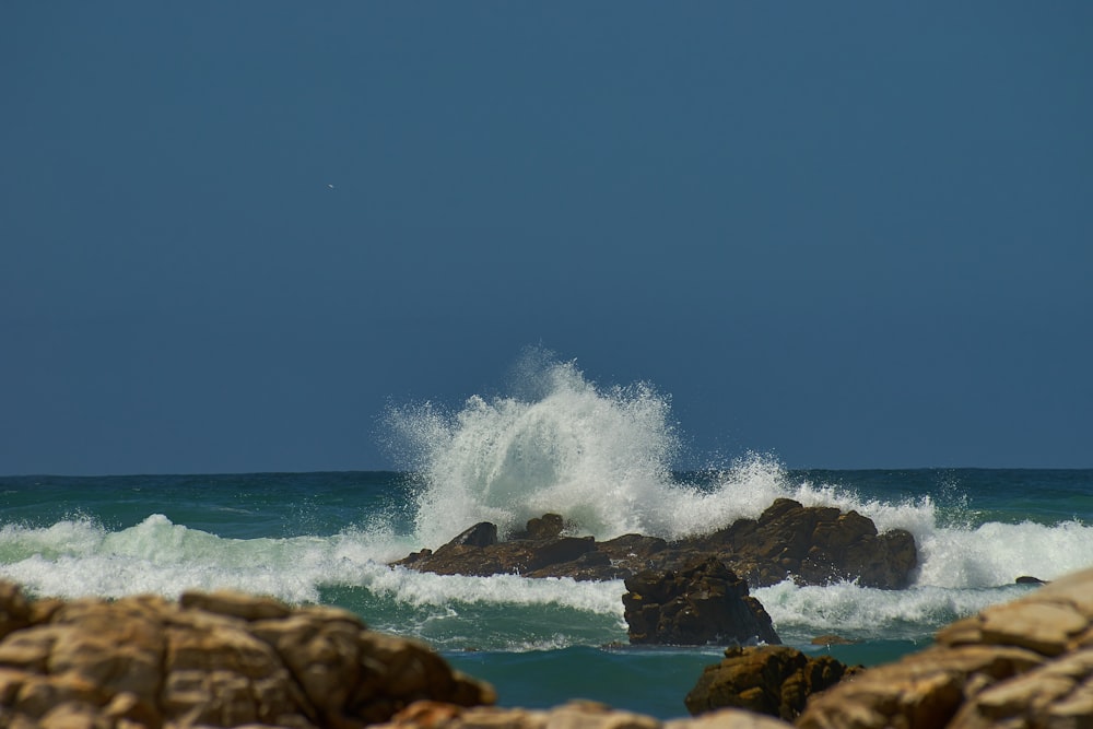 rock formations on body of water during daytime