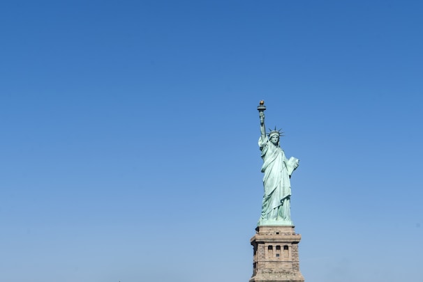 A symbolic statue representing justice and freedom under a clear sky.