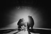 grayscale photography of two crouching men
