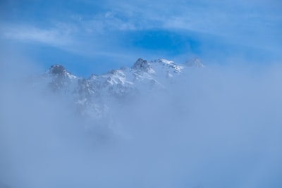 snow-capped mountain during daytime mountain range zoom background