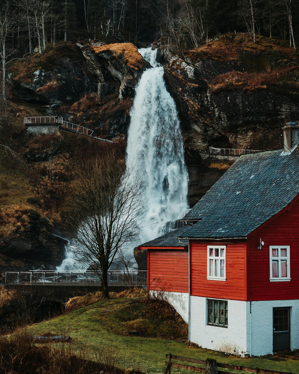white and red house near waterfalls