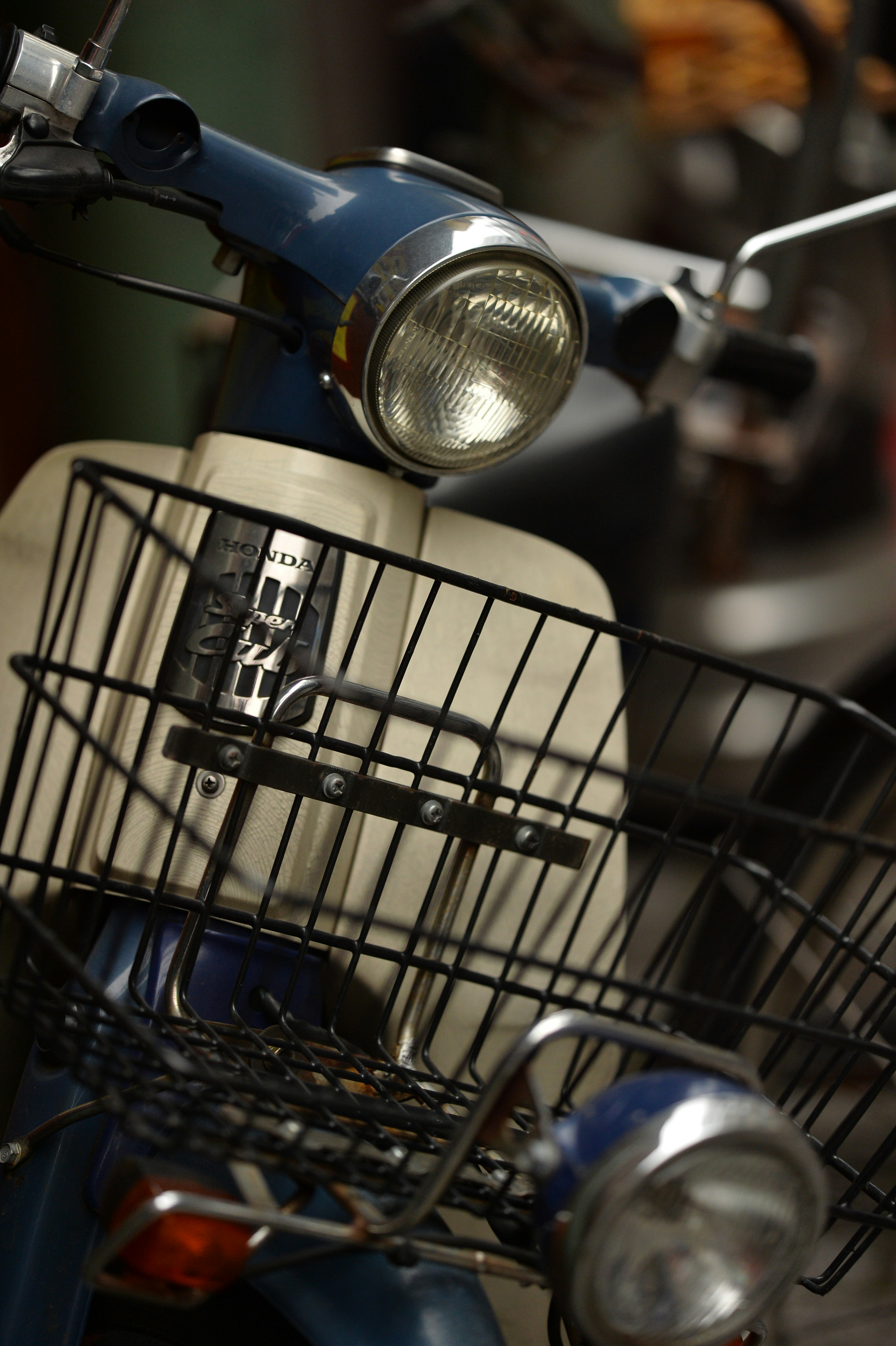 selective focus photography of parked white and blue motorcycle