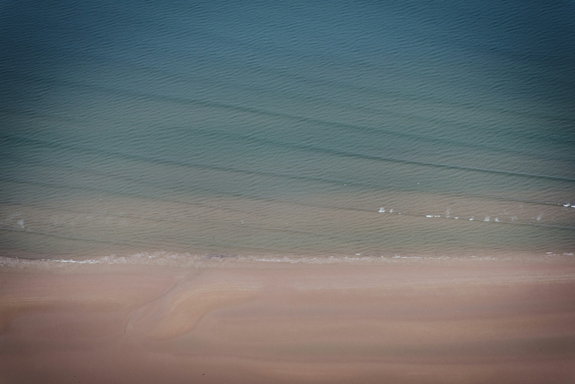 A peaceful beach scene with waves softly rolling in, perfect for a smooth horizontal slide.