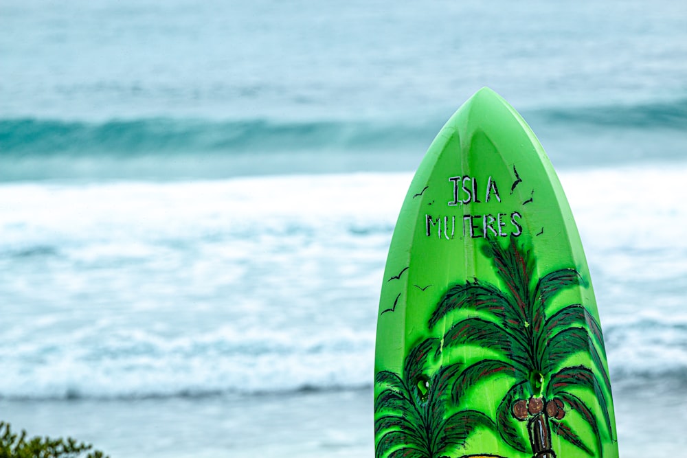 green Isla Muteres surfboard during daytime