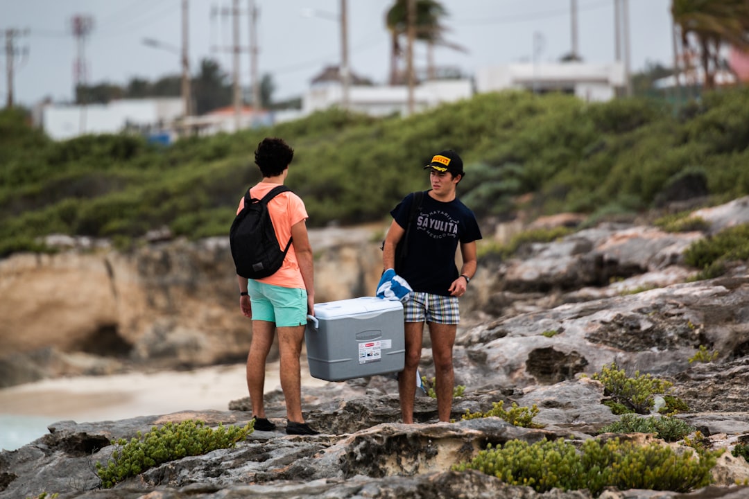 men carrying ice box