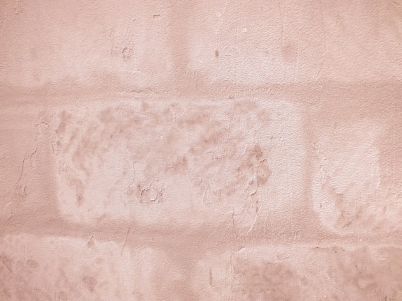 Close-up of textured wall painted with a warm beige tone from Serracor Atacadão.