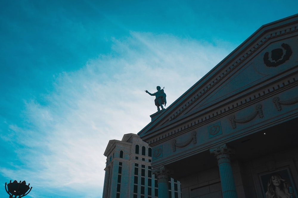 person on horse statue on top of building