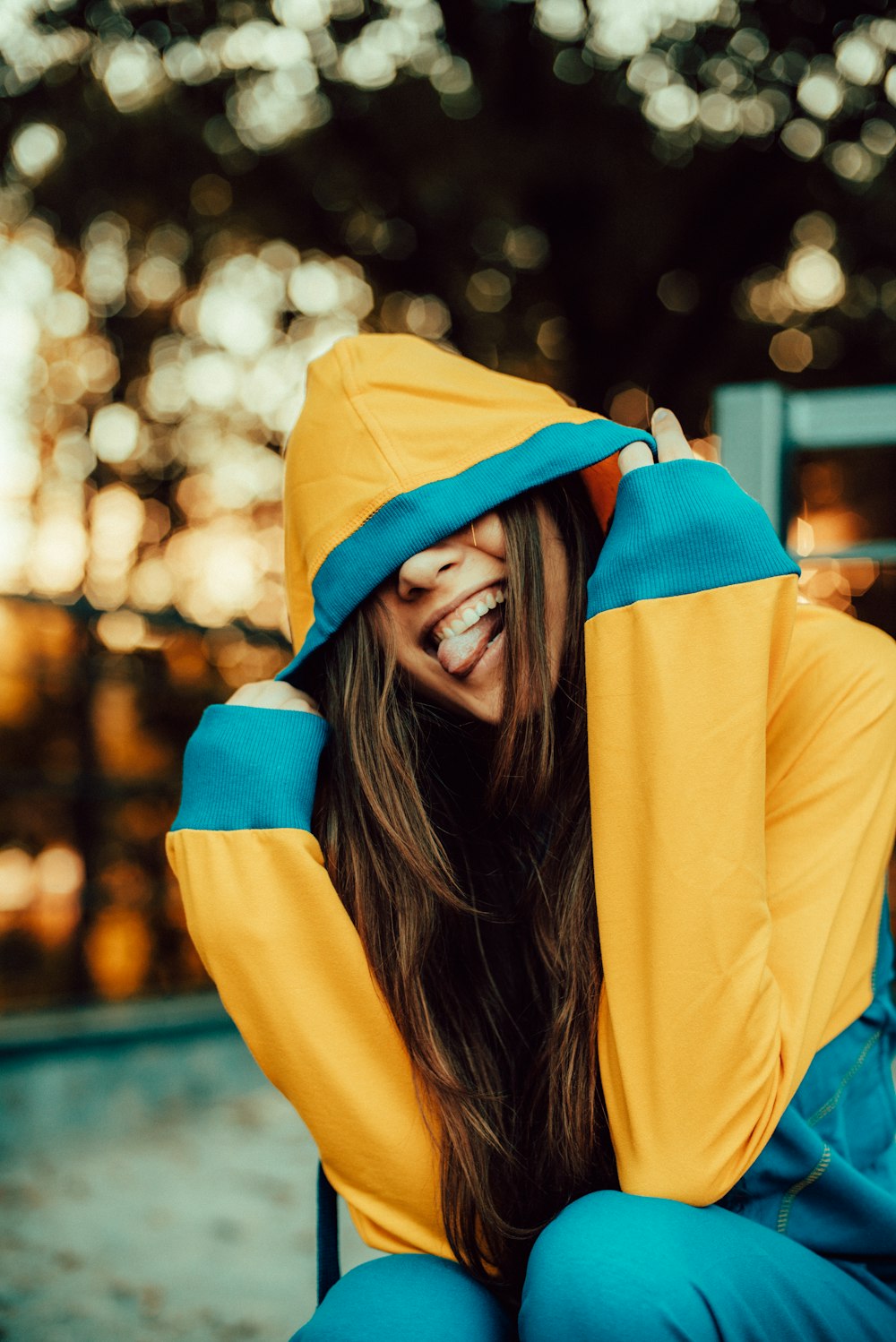 selective focus photography of yellow and blue hoodie