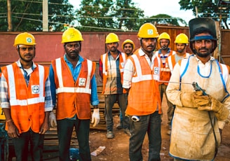 men wearing reflective vest and hard helmets