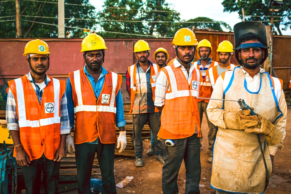 men wearing reflective vest and hard helmets