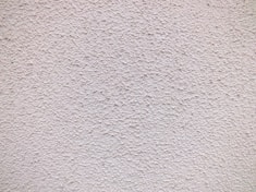 a close up of a white stucco wall