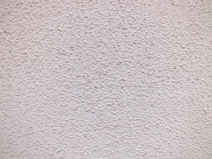 a close up of a white stucco wall