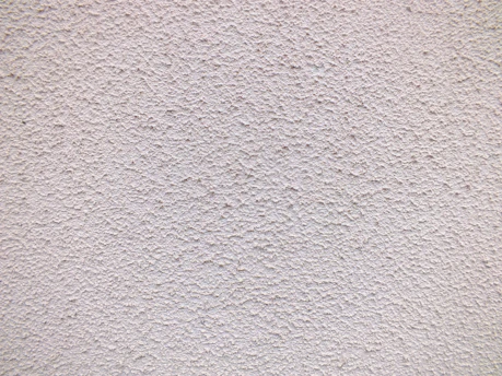 a close up of a white stucco wall