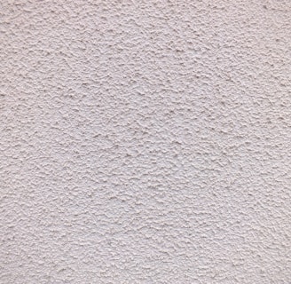 a close up of a white stucco wall