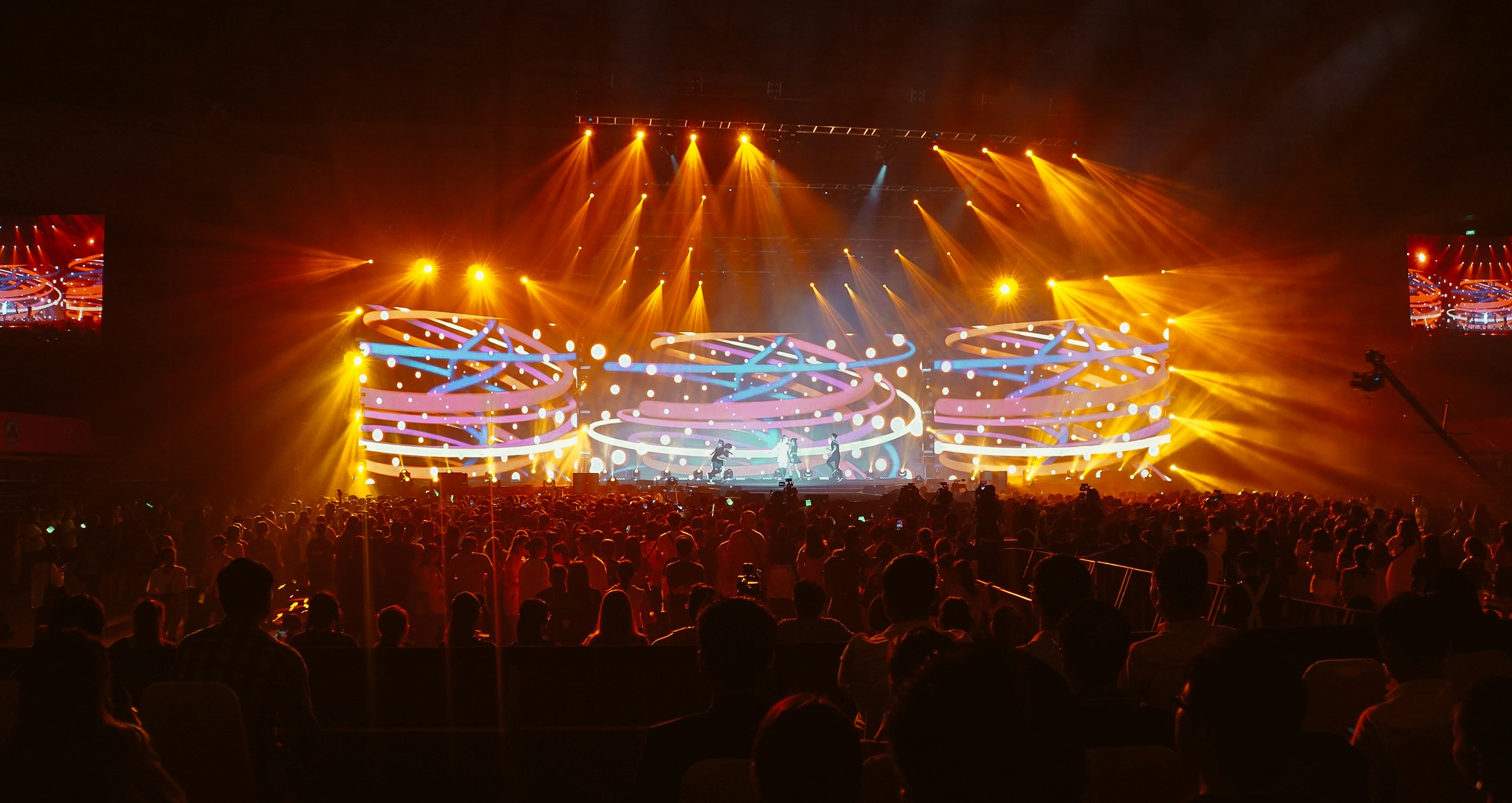 crowd in front of lighted stage