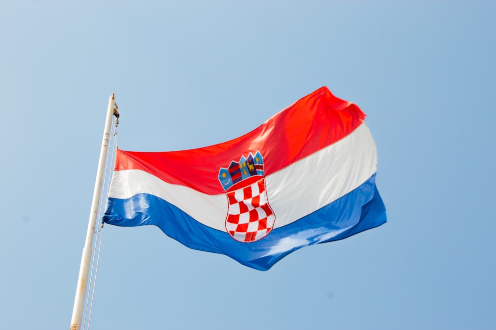 red, white, and blue striped flag on pole