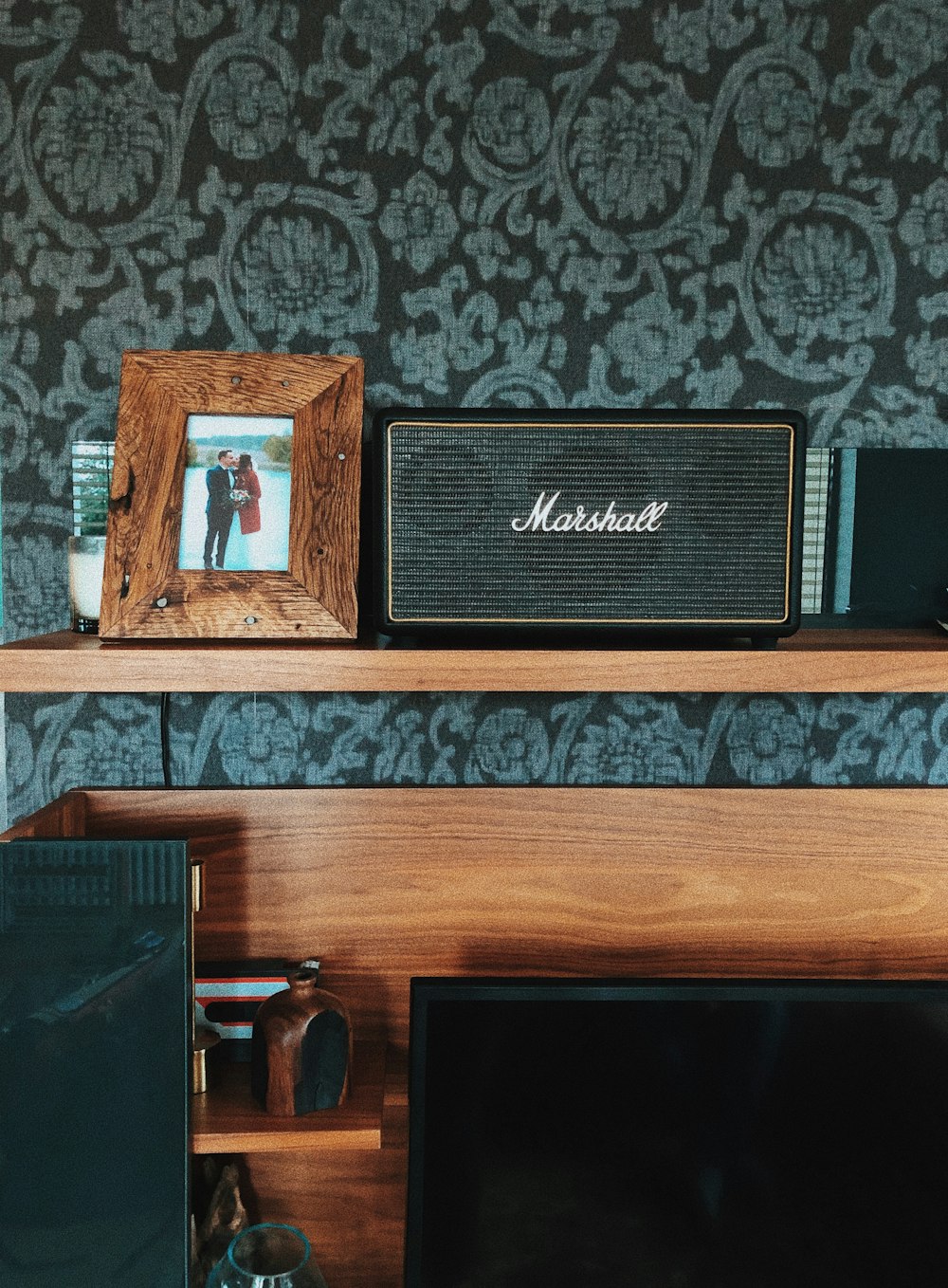 black Marshall speaker beside photo frame