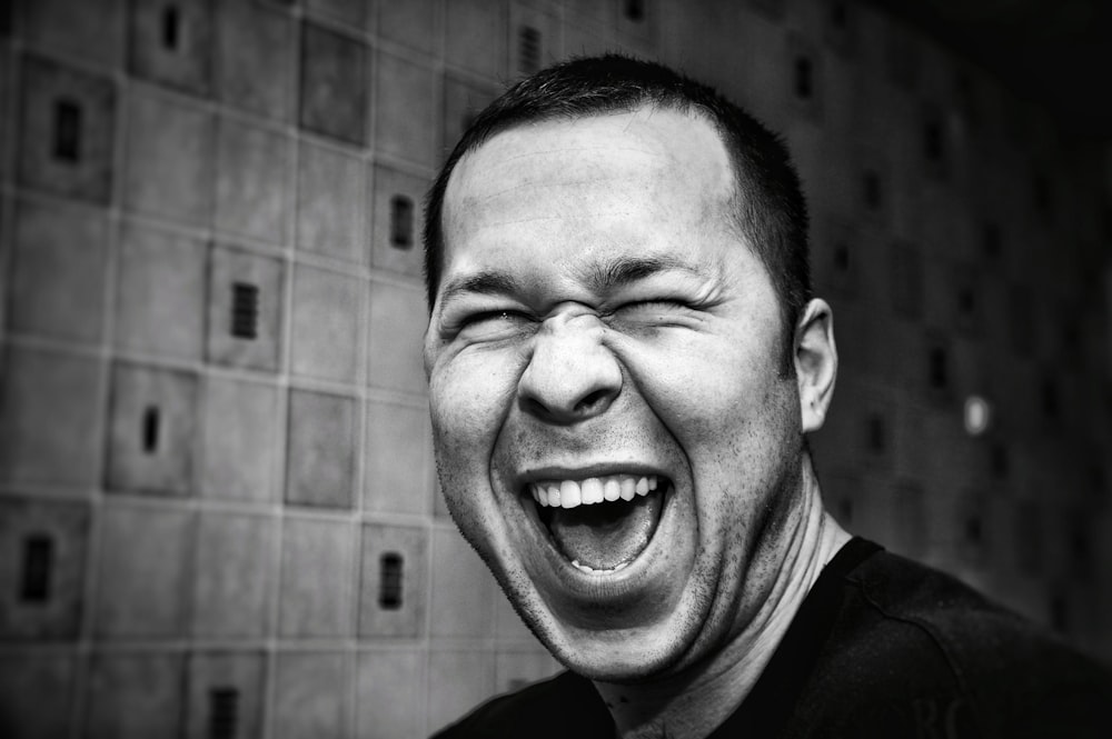 grayscale photo of man making silly face