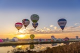 flying hot air balloons during golden hour