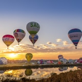 flying hot air balloons during golden hour