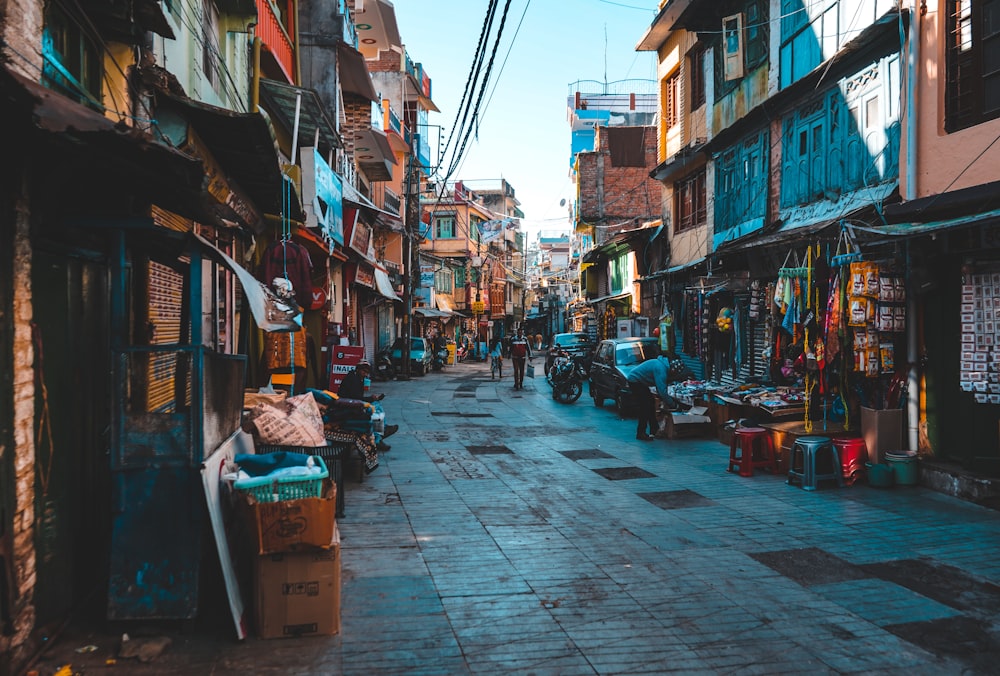 a narrow city street lined with buildings and shops