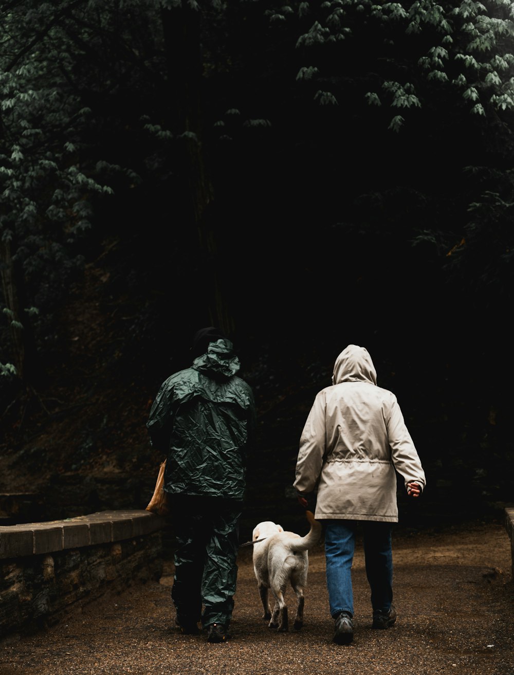 man and woman walking with dog