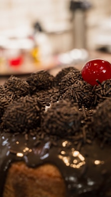 A vintage-style chocolate cake topped with rich frosting and decorative swirls.