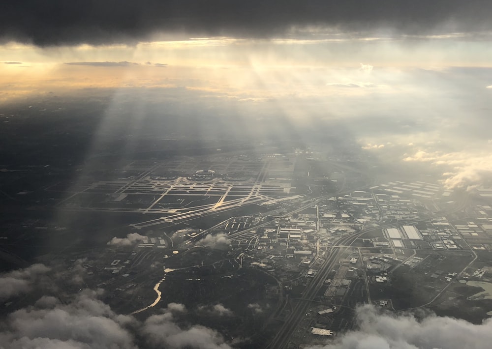 the sun shines through the clouds over a city