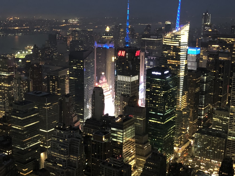 a view of a city at night from the top of a skyscraper