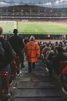 Arsenal players celebrating a goal during a lively match at Emirates Stadium.