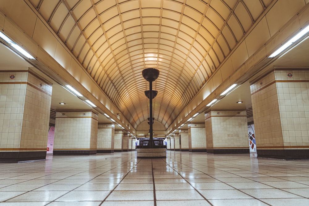 an empty train station with a clock on the wall