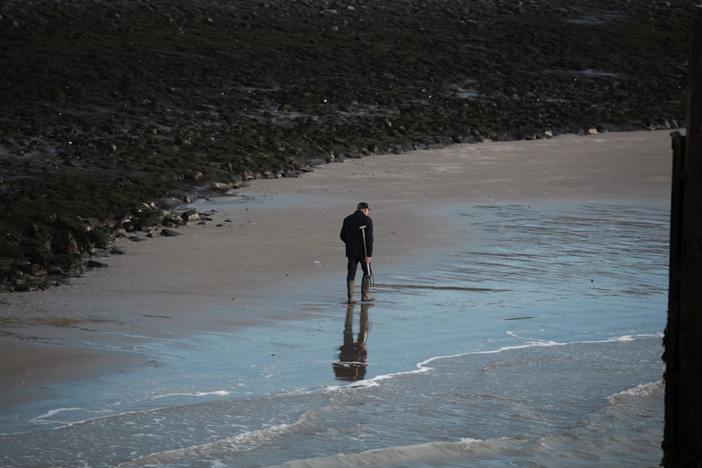 man walking on seashore