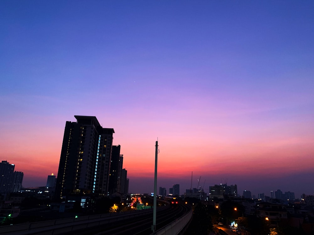 a view of a city skyline at dusk