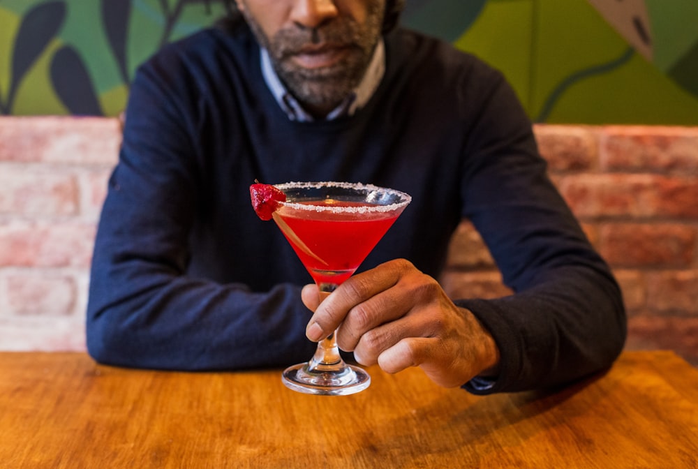 man holding martini glass
