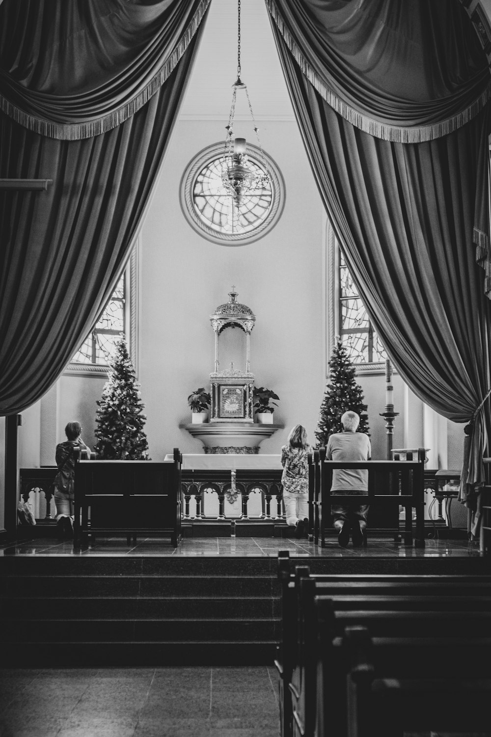 grayscale photography of people in cathedral