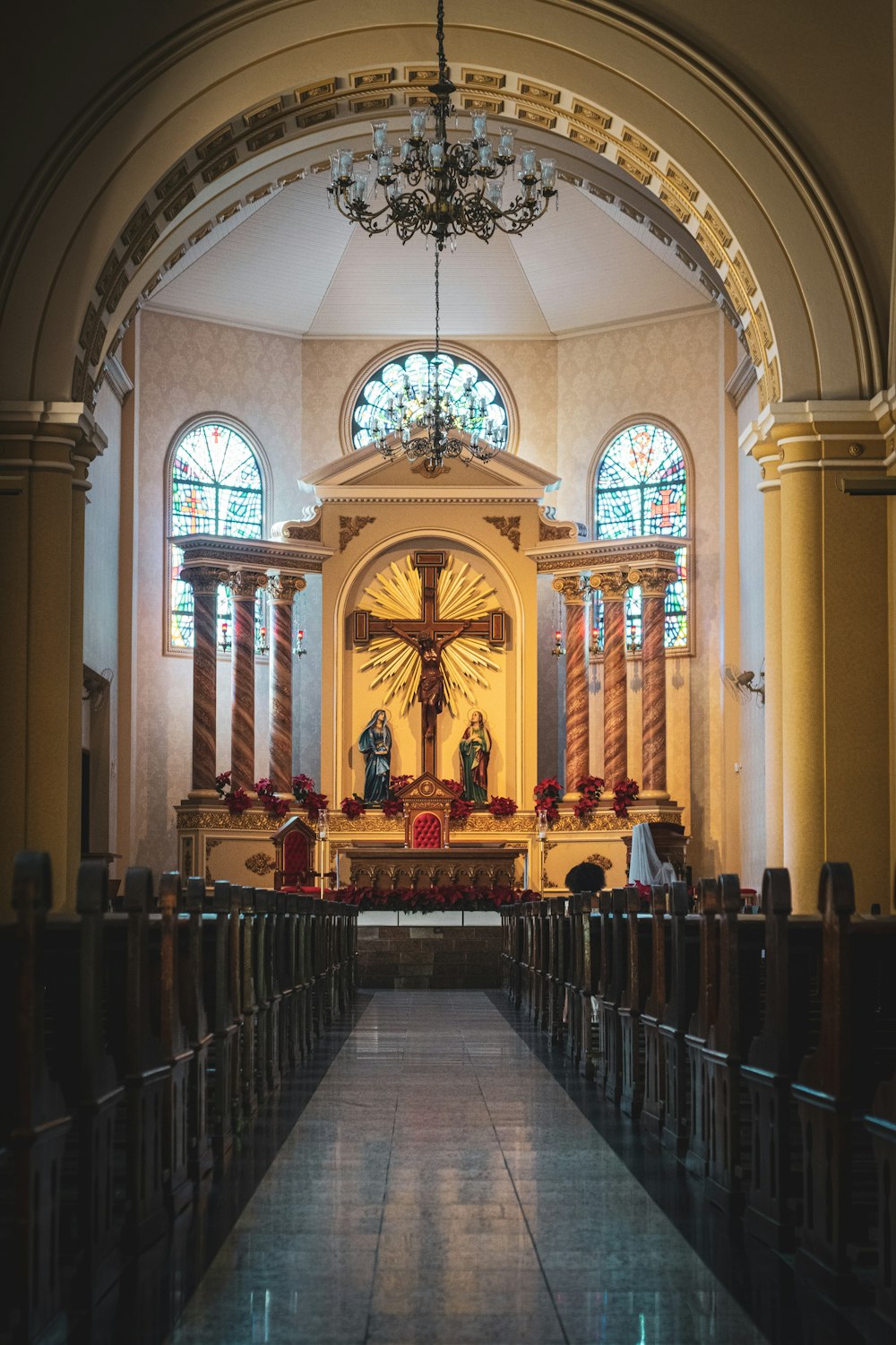 the inside of a church with pews and stained glass windows