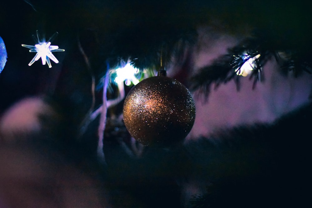 selective focus photography of brown bauble on Christmas tree