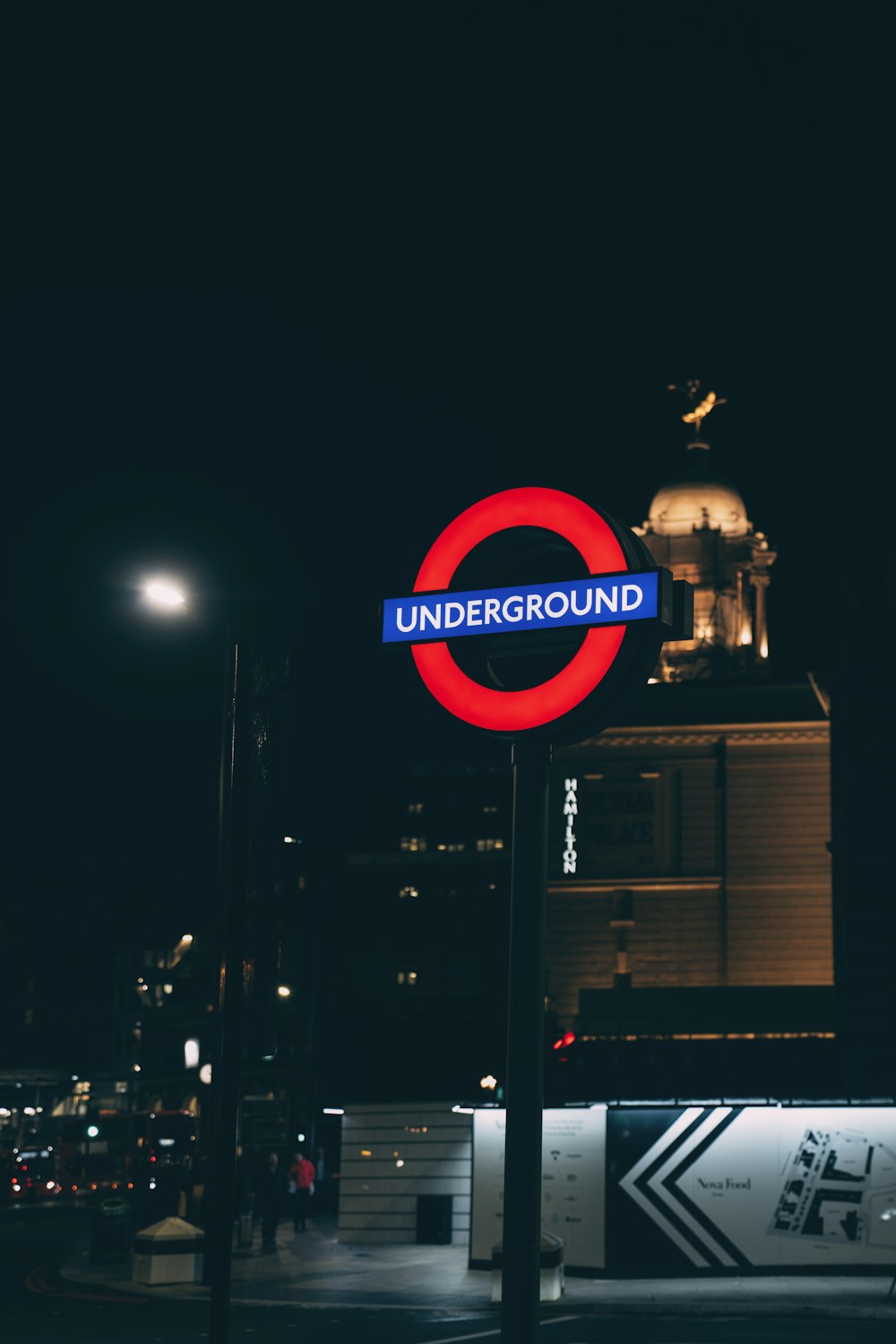 Underground LED signage on post at the city during night