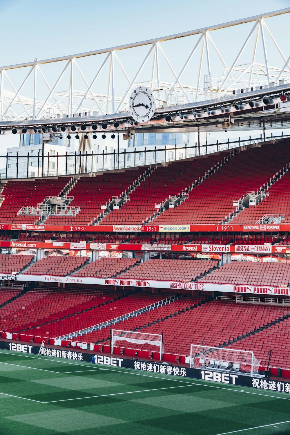 soccer stadium under white and blue sky