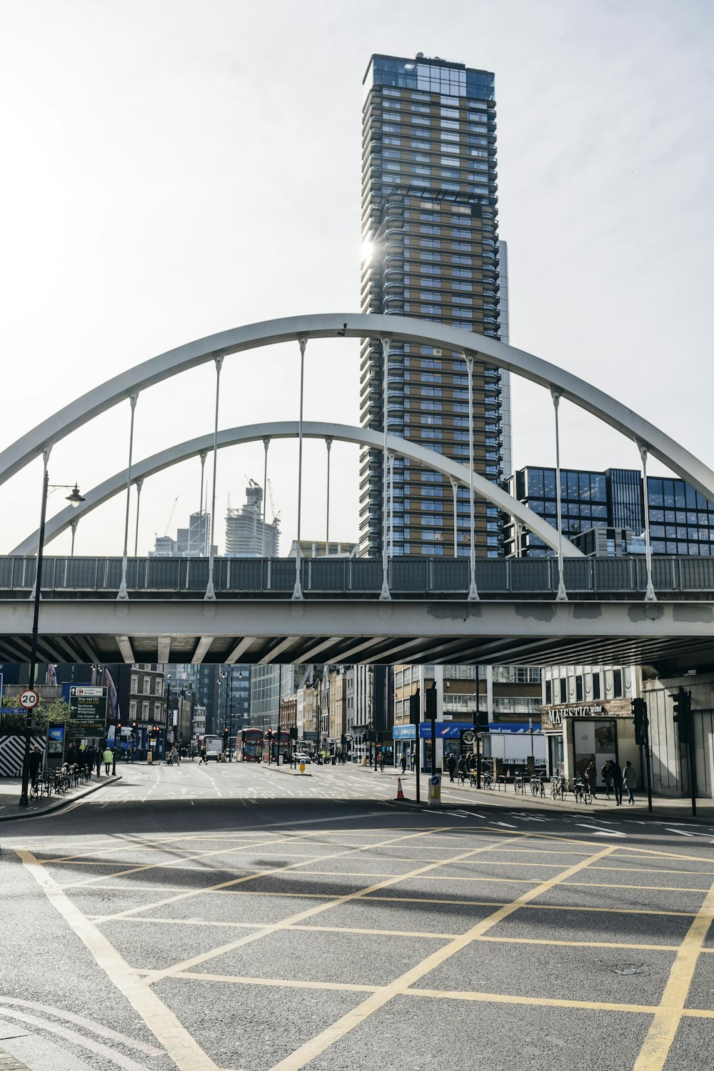 people walking near road viewing high-rise buildings during daytime