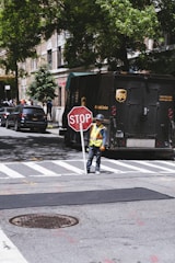 man holding stop street signage