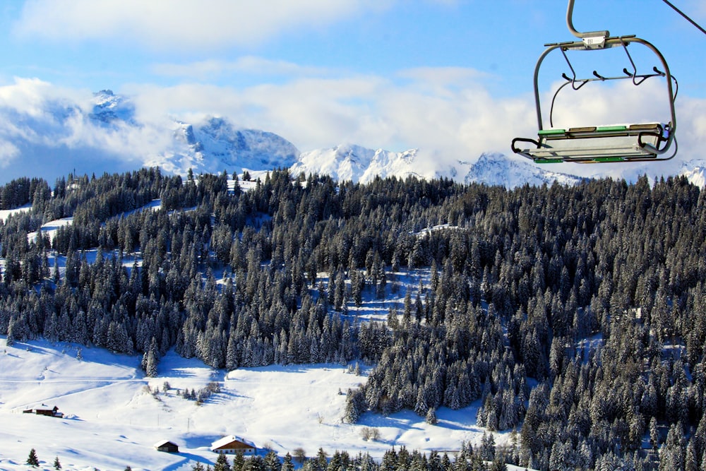 cable car above snowy field under white and blue sky