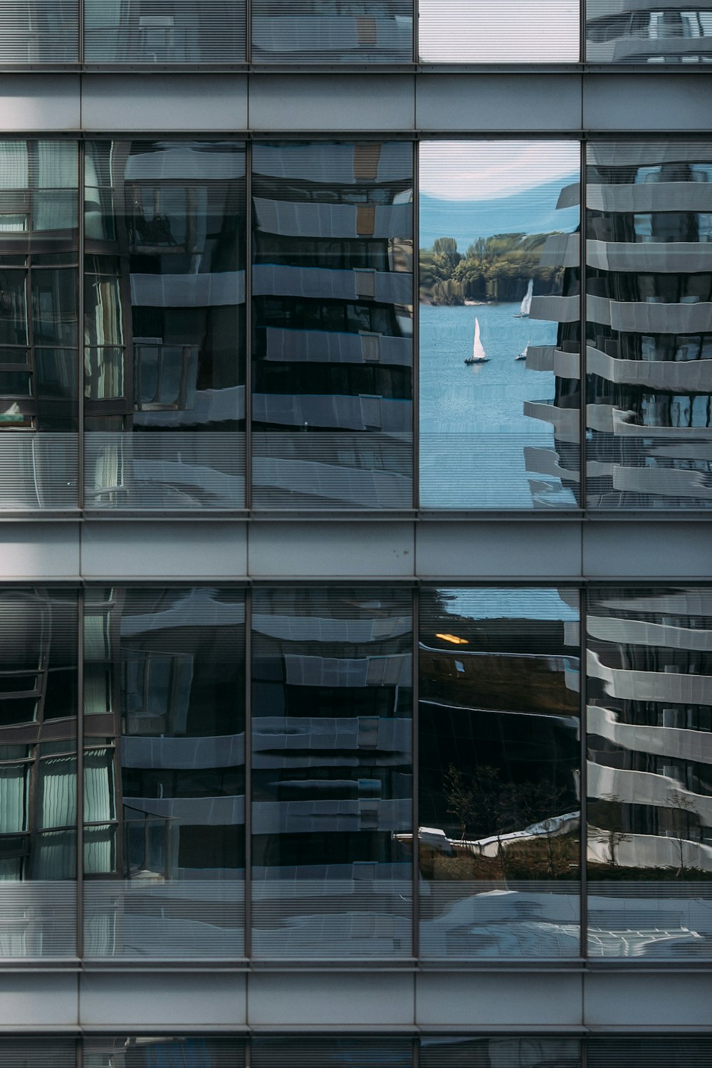 sailing boat reflecting on building's wall