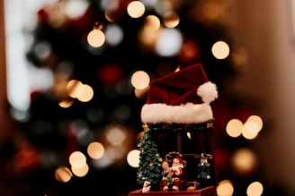 A cozy scene featuring classic red Christmas hats arranged on a rustic wooden table with soft fairy lights in the background.