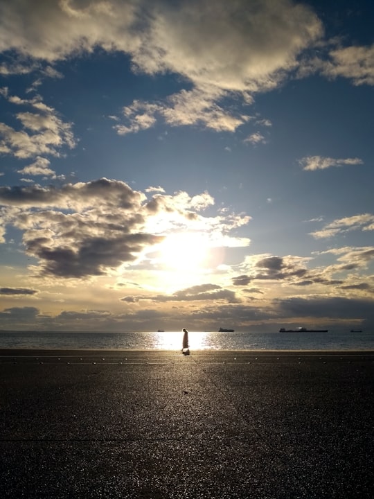 person walking on shore in Thessaloniki Greece