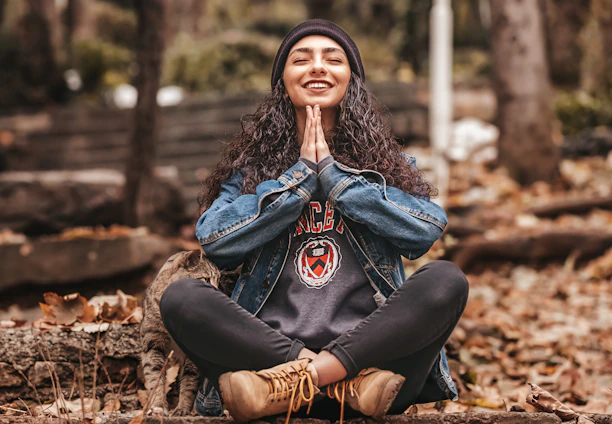 woman in meditation pose smiling
