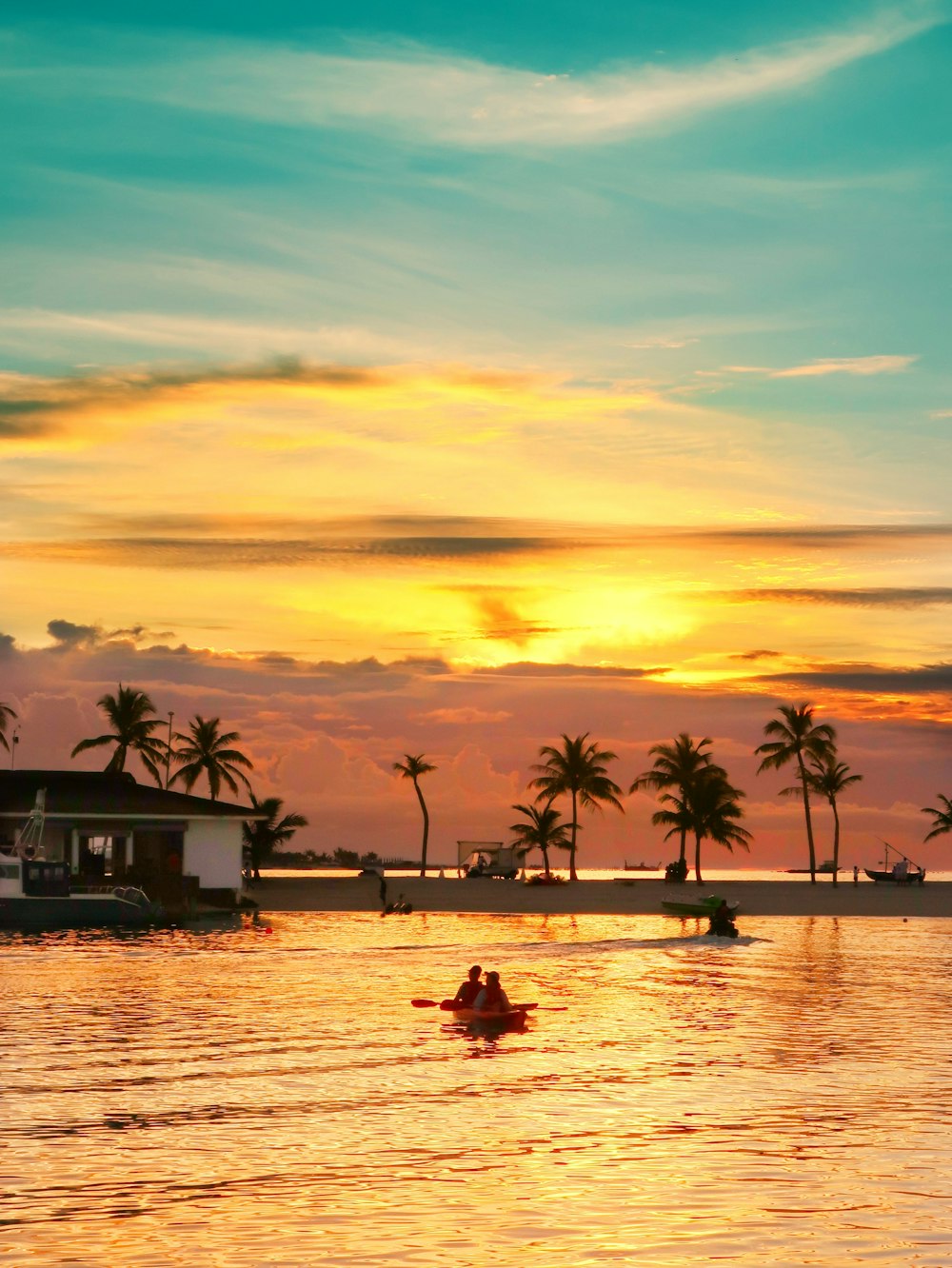 silhouette photo of two person riding kayak